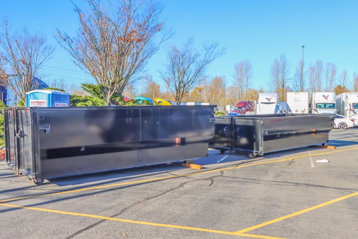 Professional dumpster rental service with roll-off container on residential driveway in Leander